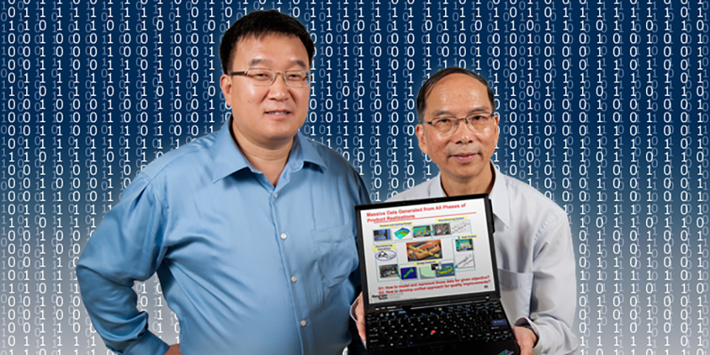 Professor Shi and Professor Wu holding a laptop